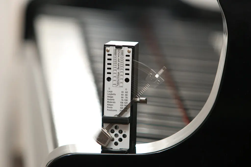A metronome standing on a piano