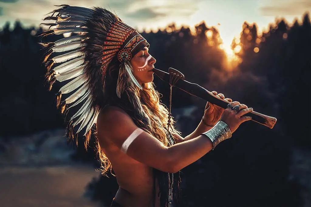 Beautiful indigenous woman playing flute