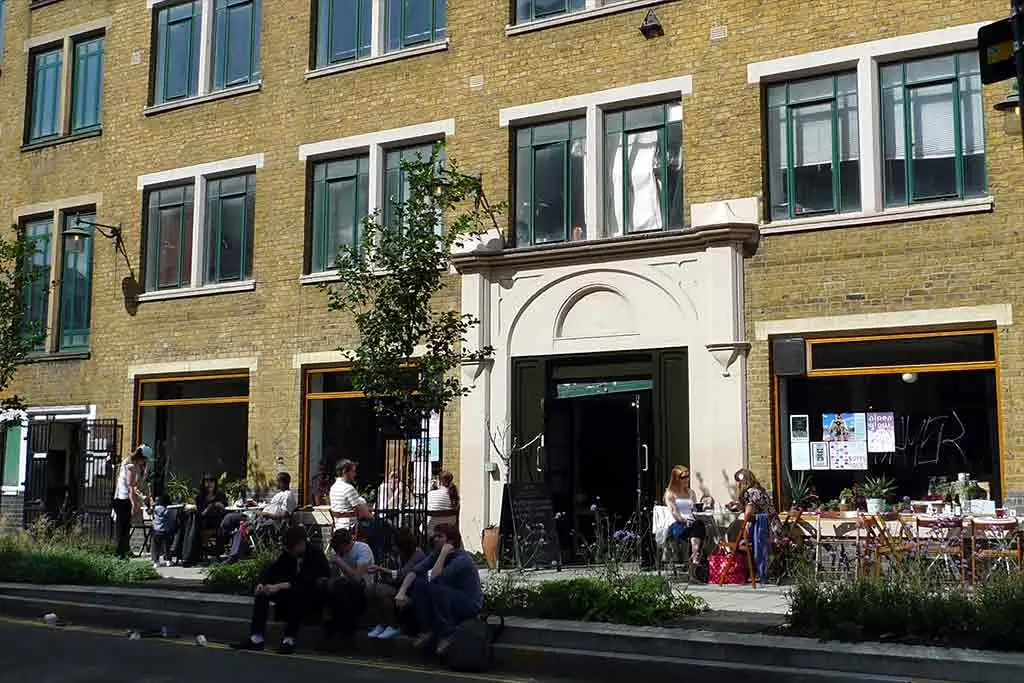 People sitting and standing outside Cafe OTO