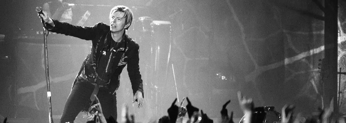 David Bowie singing and entertaining on stage with the crowd