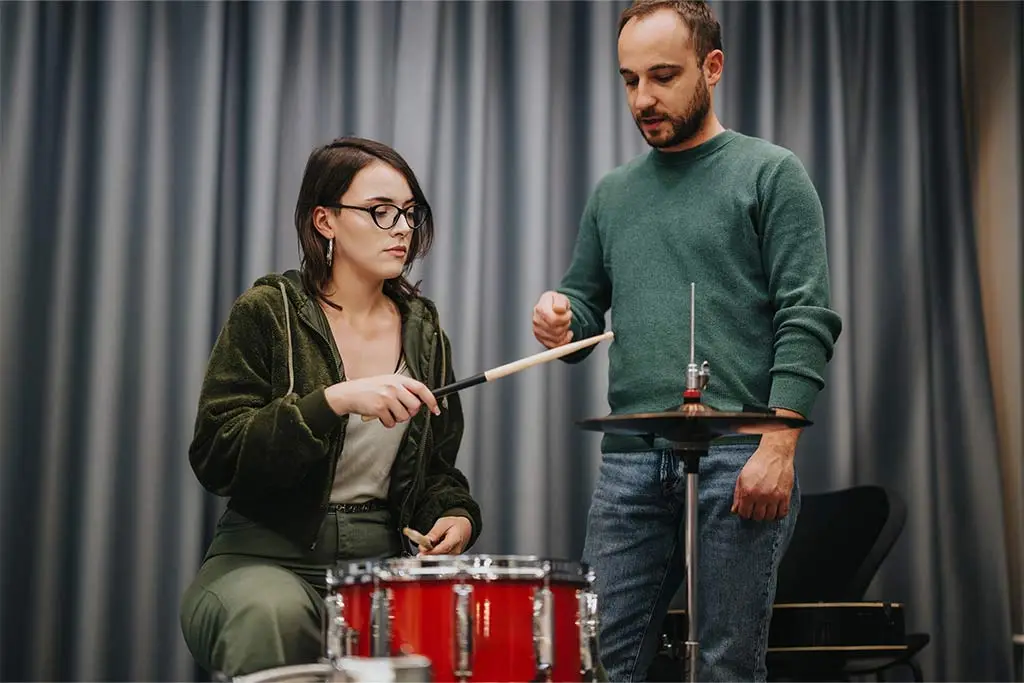 Drum teacher and student having lesson