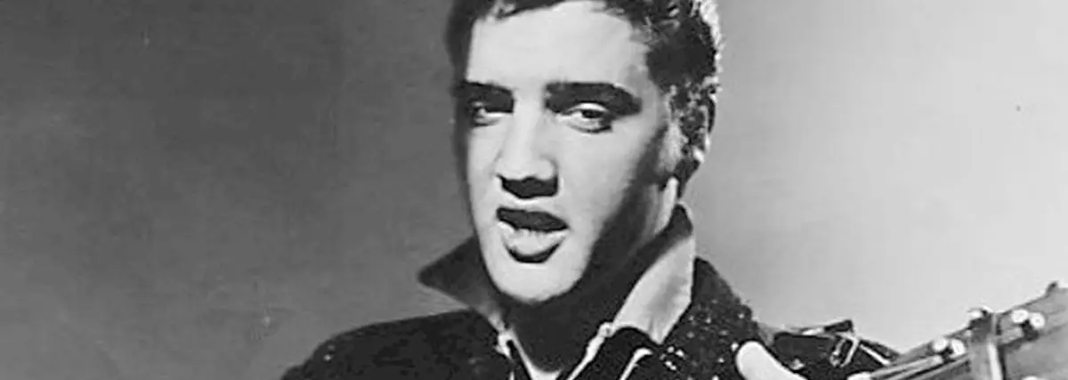 Elvis Presley holding a guitar