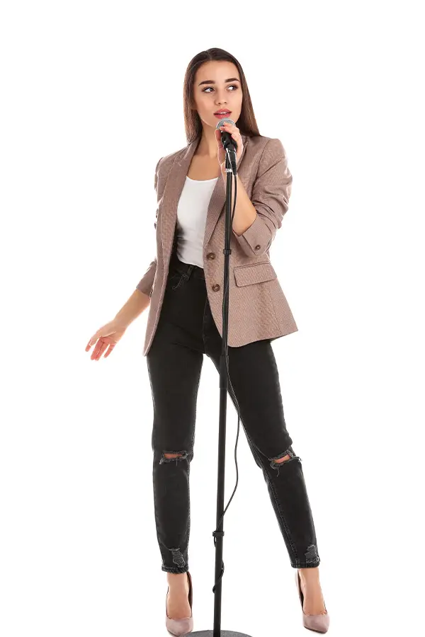 Woman singing into a microphone on a stand