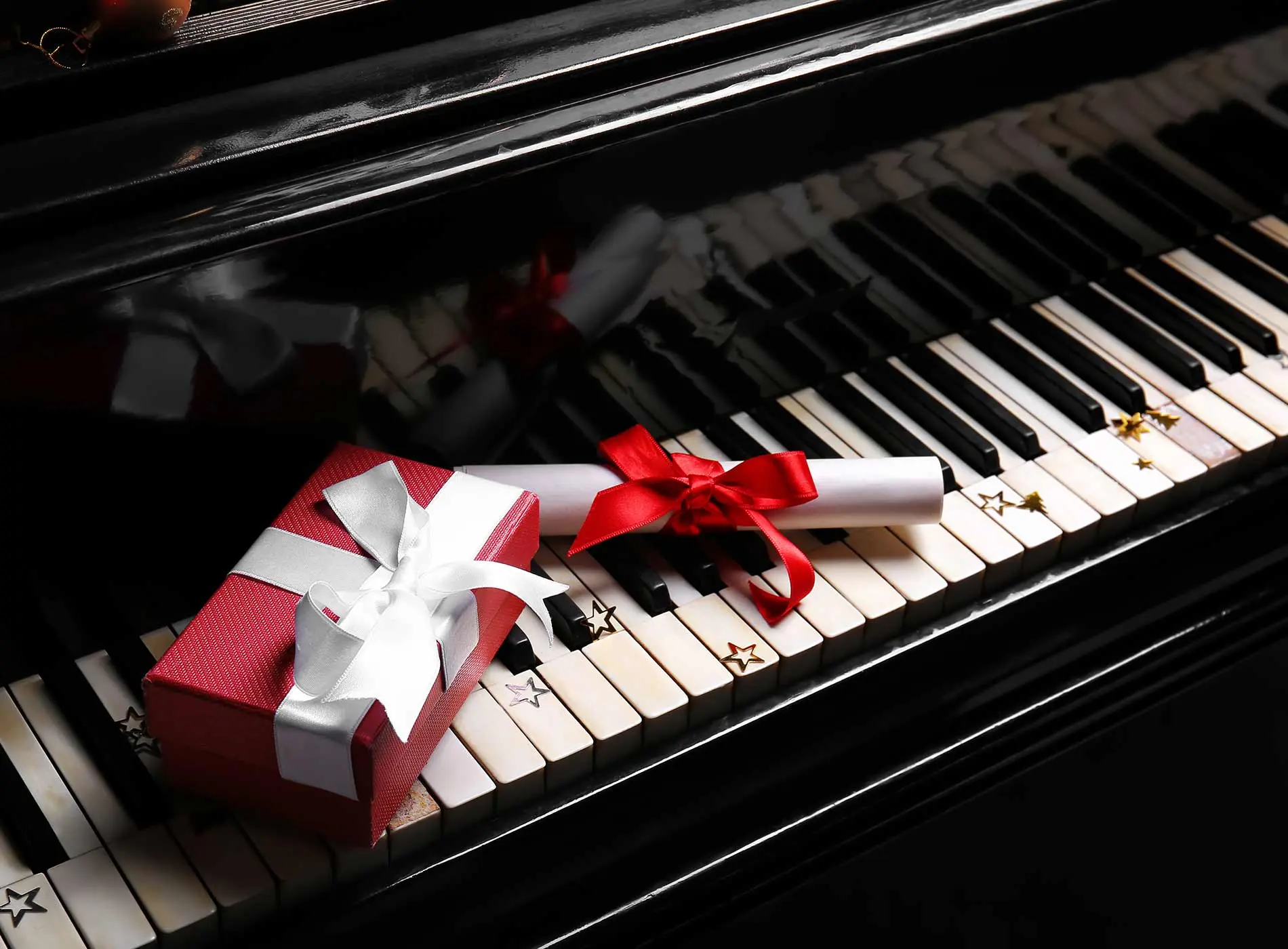 Gift box and voucher on piano keys