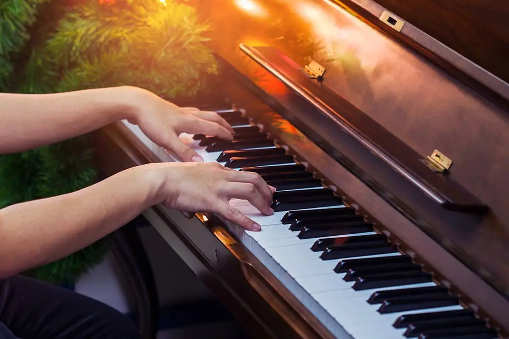 Hands on piano keyboard