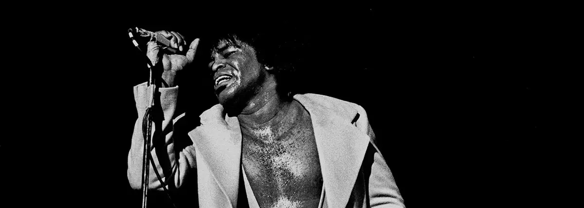 James Brown singing and performing on stage