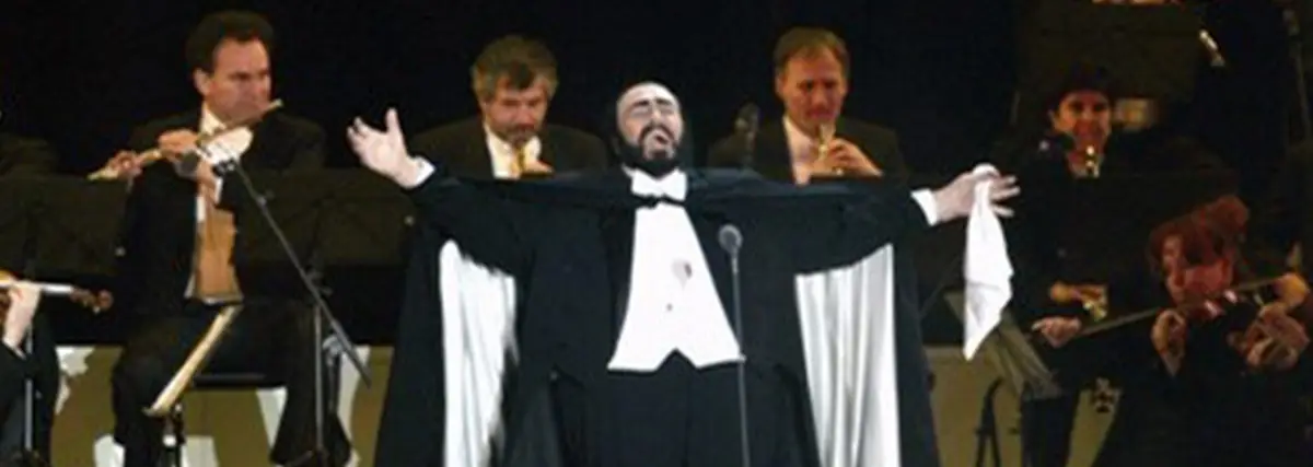 Luciano Pavarotti singing opera on stage