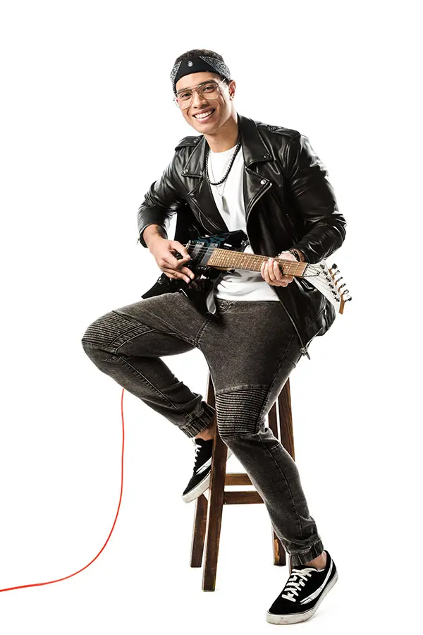 Smiling man in a bandana playing an electric guitar