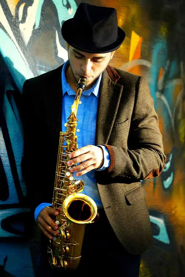 Man in hat playing saxophone