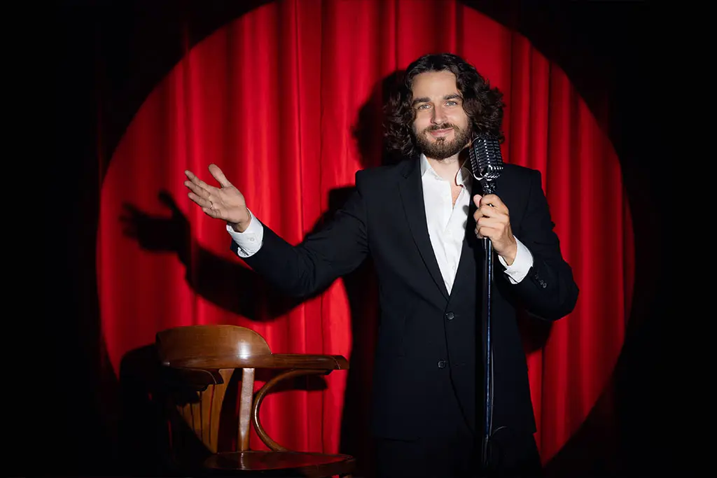 Man in stage holding a microphone