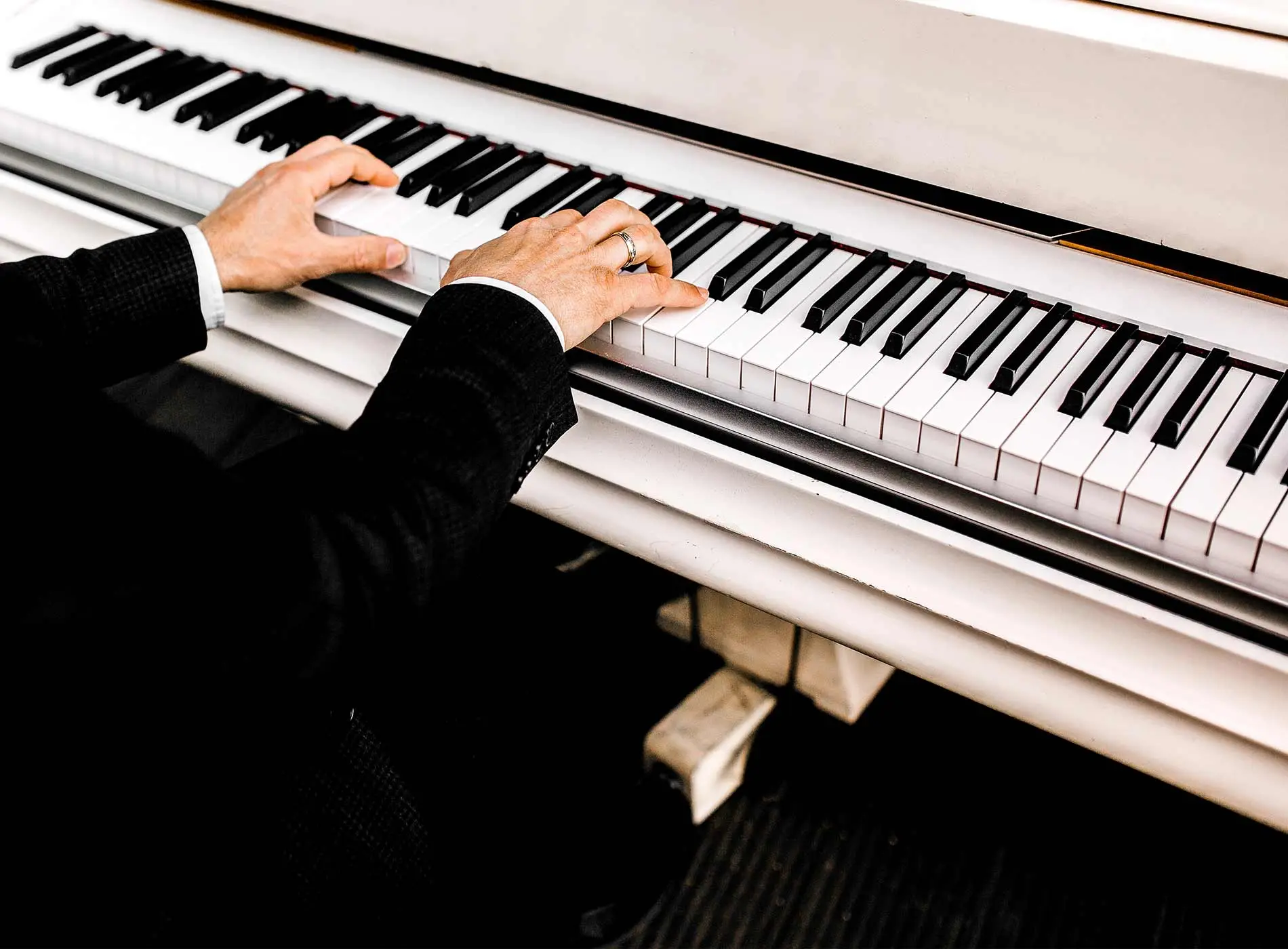 Man in suit playing piano