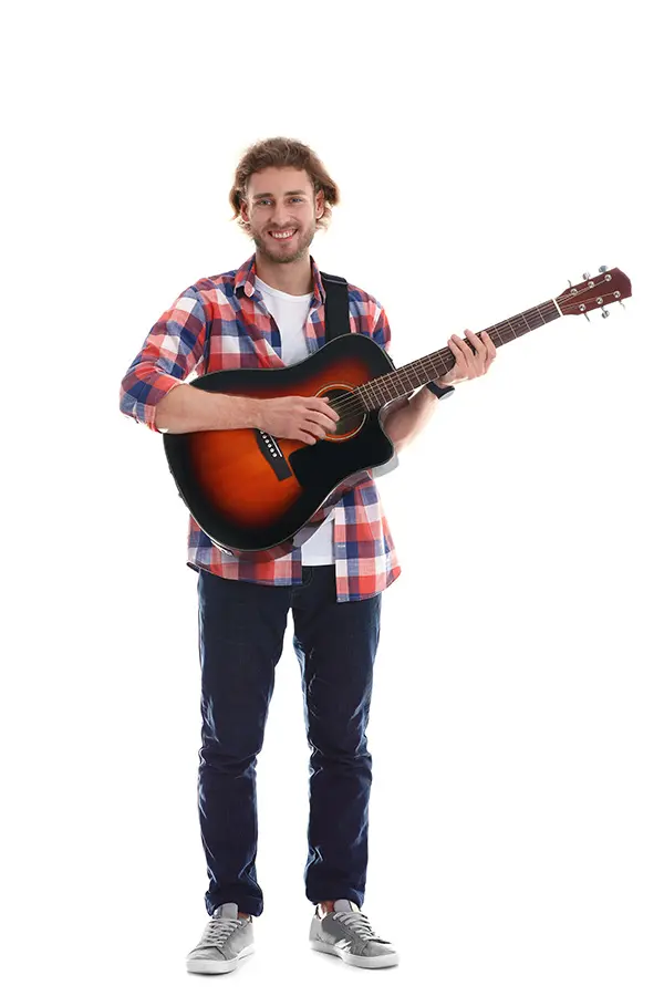Smiling man in a plaid shirt holding an acoustic guitar