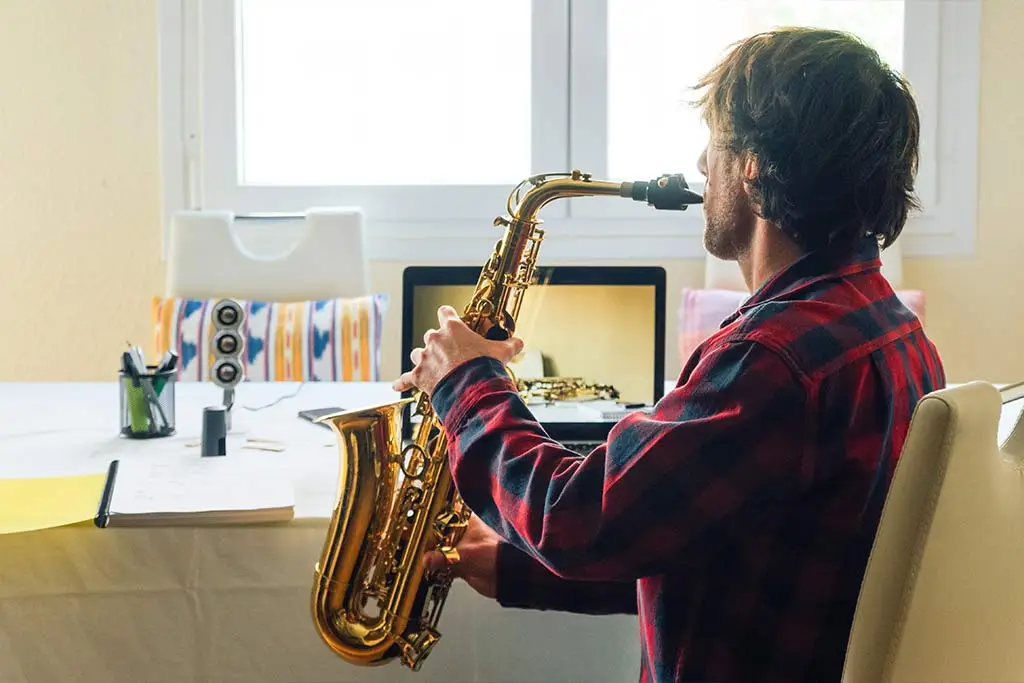 Man sitting playing saxophone