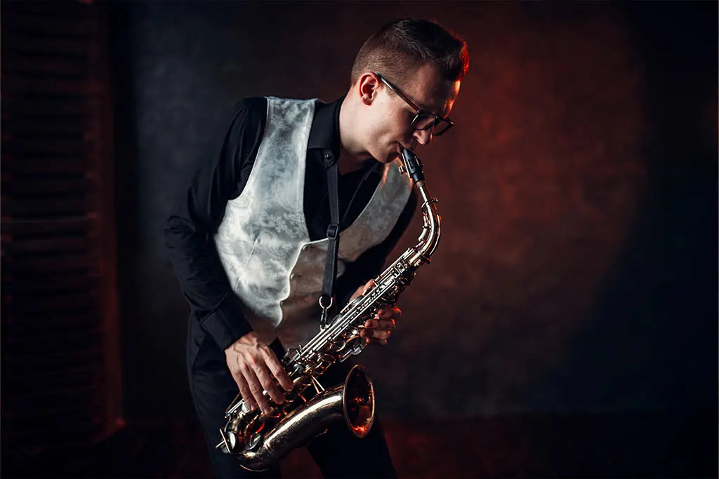 Man wearing a vest playing the saxophone