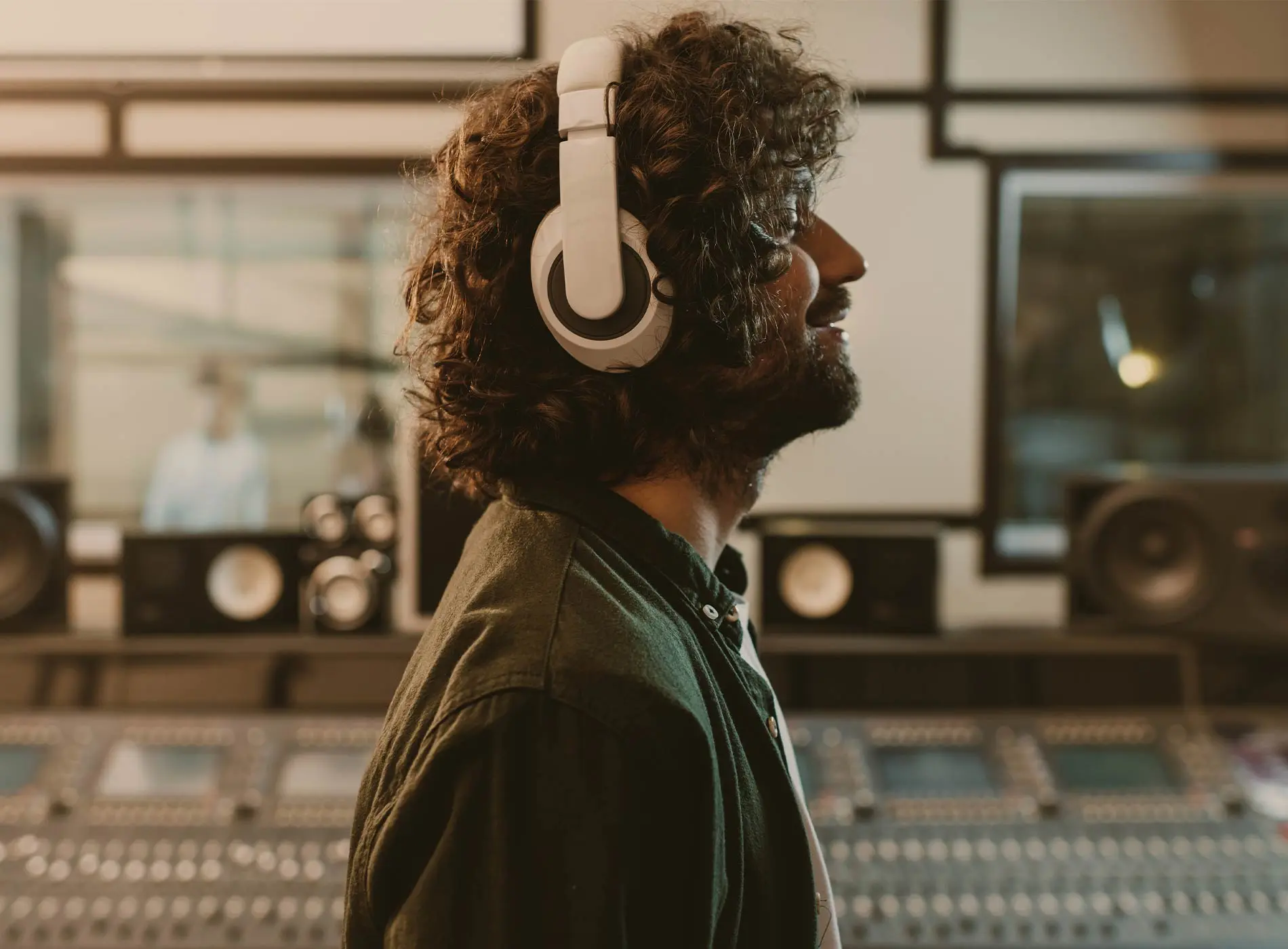 Man with headphones on listening to music inside the studio