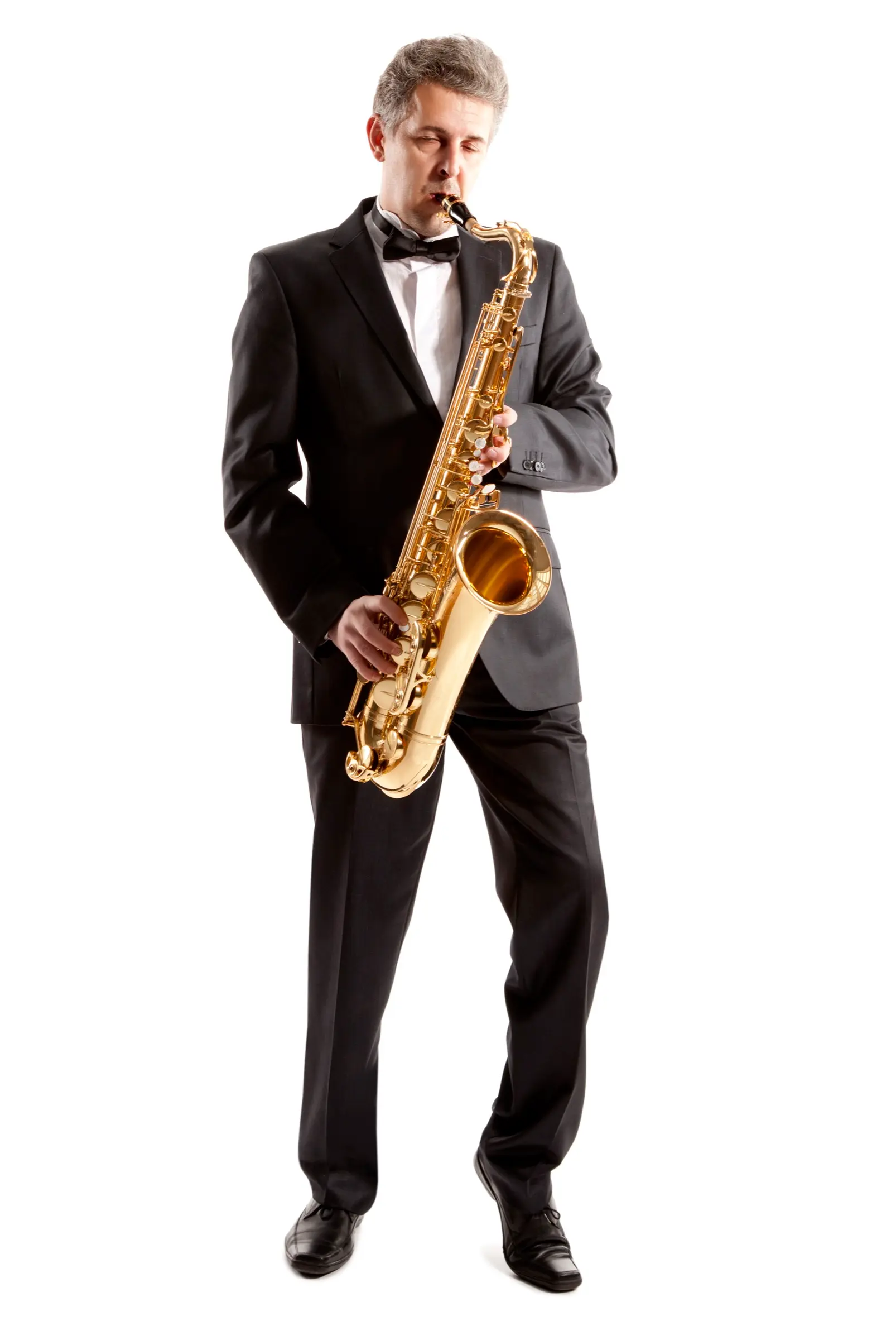 Saxophonist in a tuxedo playing against a white background.