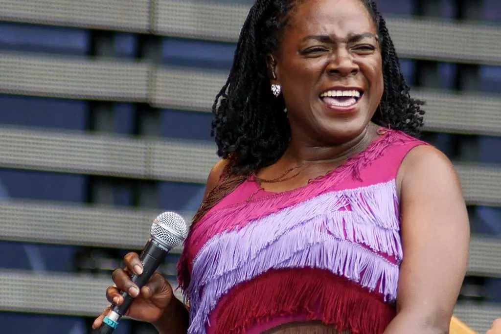 Image of Sharon Jones smiling while singing