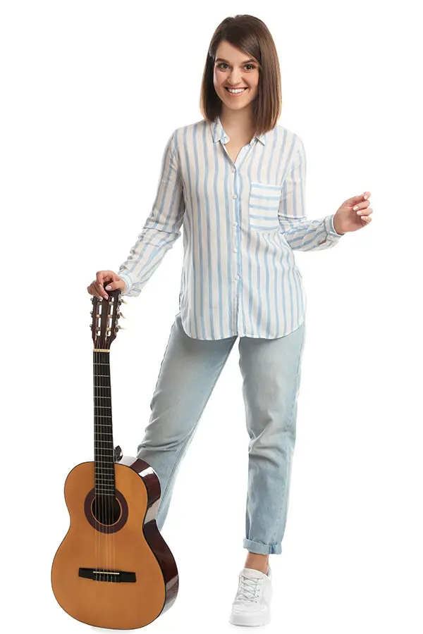 Smiling woman in a striped shirt with a classical guitar