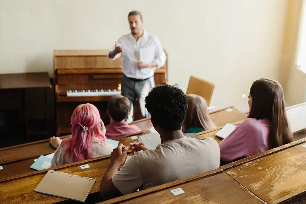 Teacher and group of students having music lesson