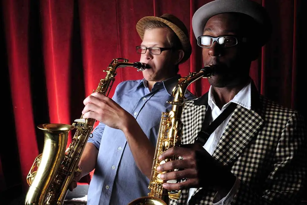 Two saxophone players playing together