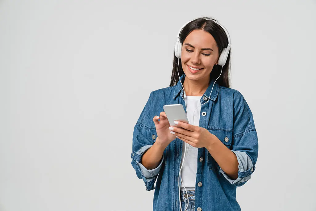 Woman with mobile phone and headphones on